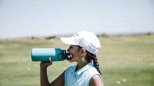 woman drinking at blue sports bottle outdoors
