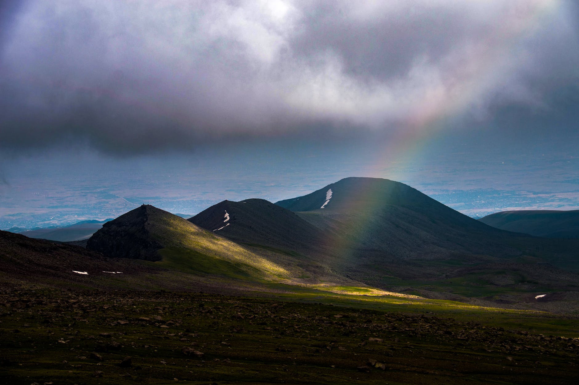 green mountain under white clouds